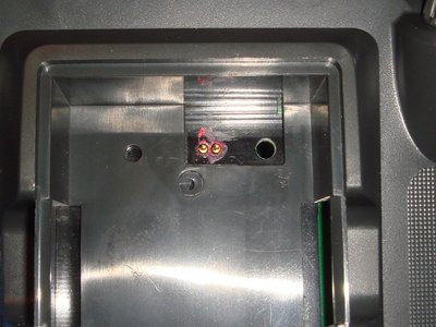 this is what it looks like in the cavity.  red dot is the Tx  txd.  The spring loaded pin is flash with the bottom of the cavity but higher than the Tx pcb board.  The pink stuff sround the hole is nail polish to prevent any contact of the pins to the hole.  there are very thick copper 'plate' on the Tx back pcb board on both sides.